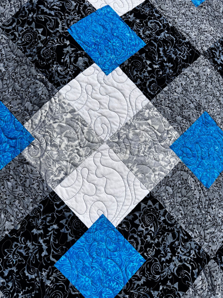 
                    
                      Quilt with blue, white, and black diamond pattern
                    
                  